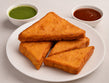 crispy besan-coated bread pakora triangles served with green chutney and tea