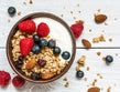 bowl of crunchy oat clusters with nuts, seeds and dried fruit