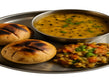 Rajasthani platter of baked baatis, spiced dal and sweet crumbly churma
