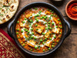bowl of soft paneer cubes and green peas in a rich onion-tomato gravy